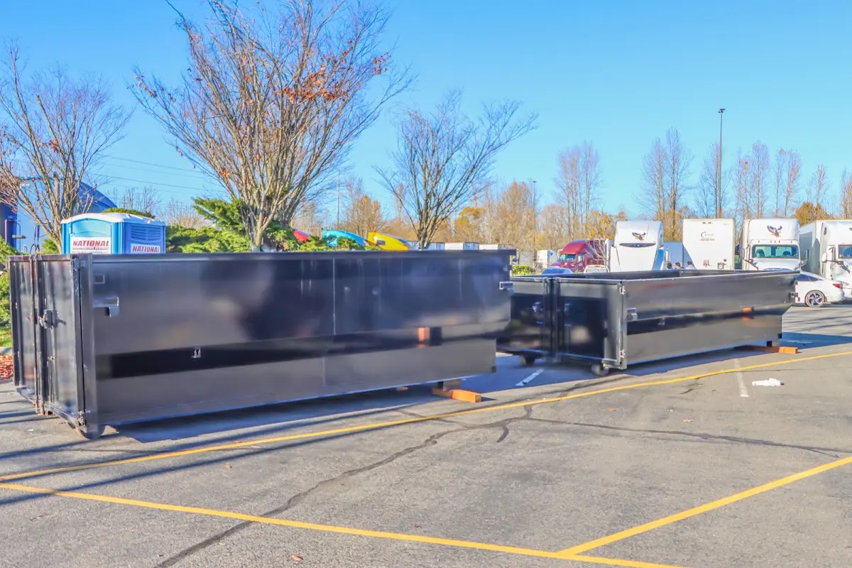 Professional dumpster rental service with roll-off container on residential driveway in Junction City